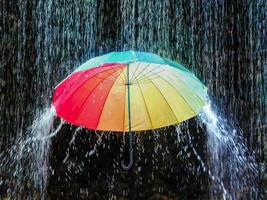 A colorful umbrella under the pouring monsoon rain photo