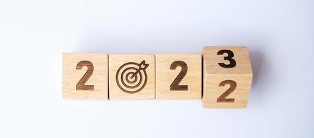 hand flip 2022 to 2023 block with dartboard sign. Business Goal, Target, Resolution, strategy, plan, Action motivation, change, thinking, countdown and New Year start concepts photo