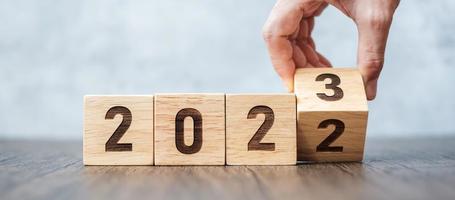 hand flip 2022 to 2023 block. goal, Resolution, strategy, plan,, motivation, reboot, forecast, change, countdown and New Year holiday concepts photo
