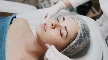 Dermatologist applying facial product on woman video