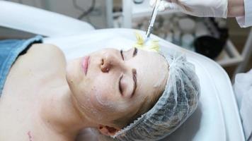 Dermatologist applying facial product on woman video