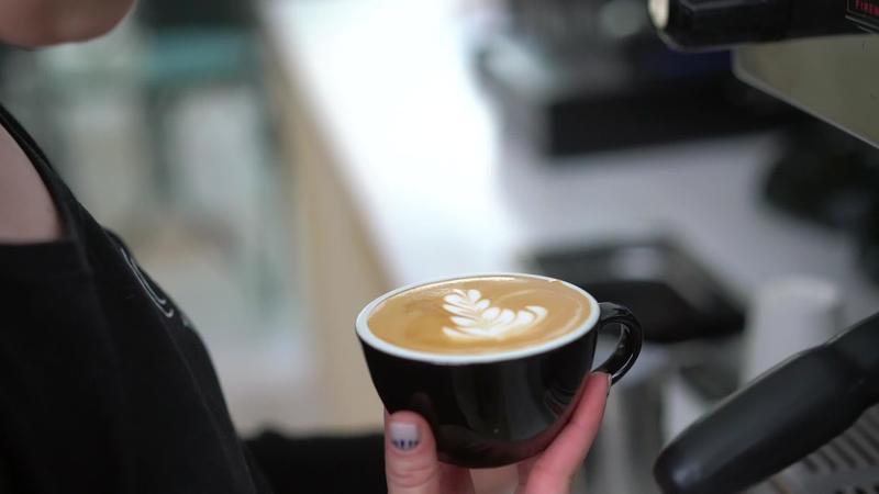 Barista preparing a delicious cup of coffee 13136348 Stock Video at Vecteezy