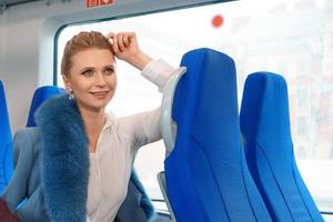 Beautiful blonde woman rides the train photo