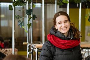 portrait of a cute girl smiling standing warmly dressed photo