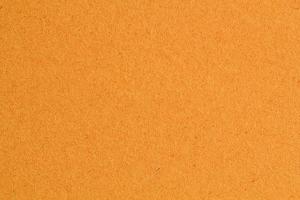 Abstract design background orange autumn recycled natural paper texture. Old fiber uneven, rough cardboard sheet seamless spotted surface pattern. Close-up, mock up, top view with copy space for text photo