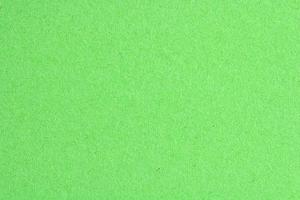 Abstract design background neon green recycled natural paper texture. Old fiber uneven, rough cardboard sheet seamless spotted surface pattern. Close-up, mock up, top view with copy space for text photo