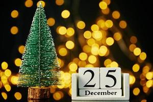 Merry Christmas and Happy New Year composition with christmas tree on dark background photo