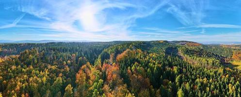 Aerial view of mountains covered with autumn forest photo