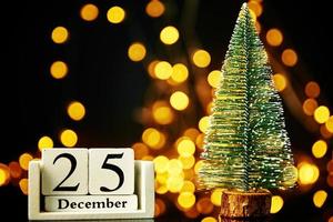 Merry Christmas and Happy New Year composition with christmas tree on dark background photo