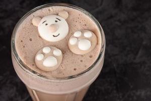 cocoa drink decorated with funny cookies on a dark background photo