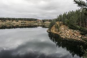 Lake view with rocky shores and pine trees, quarry, landscape photo