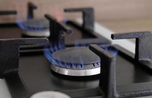 Close-up blue flames of fire on a gas burner in the kitchen for cooking. Gas flame in a gas boiler photo