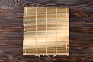 Empty Asian Food Background. brown Bamboo mat on wooden background top view with copy space flat lay photo