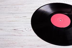 vinyl disc isolated on the wooden table photo
