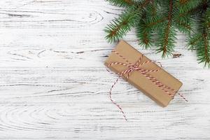 Christmas background with fir tree, gift box and decor. Top view with copy space photo