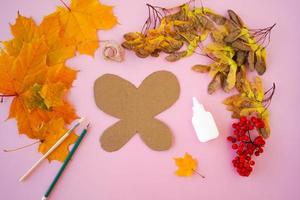 1. Step by step. Butterfly made of natural material, autumn leaves, berries, children's craft. photo