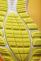 Textured design of the sole of the Tread of a sneaker in yellow Macro. photo