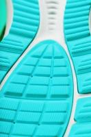 Fragment of the sole of a blue sneaker close-up. Textured texture of the material of sports shoes. photo