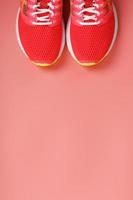 Sports pink sneakers on a pink background with free space. photo