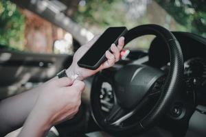 Close up and a man use cable Plug to charge mobile phone in the car , connecting data car play, music,Navigation system and charging mobile in process photo