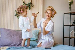 mom and daughter make a make-up to each other, happy family relationship photo