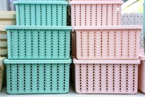 Plastic baskets on the shelf in the store photo