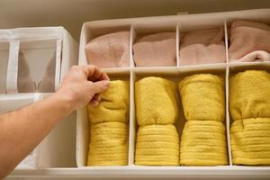 a man chooses a towel in the store photo