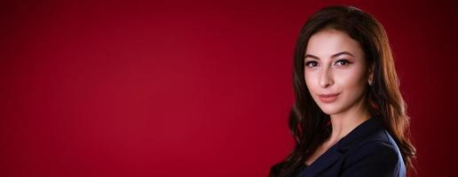 Business woman posing over red background photo