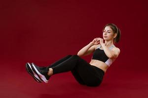 Woman goes in for sports on a red background photo