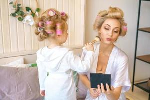 mom and daughter together happy in curlers photo