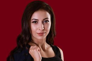 Business woman posing over red background photo