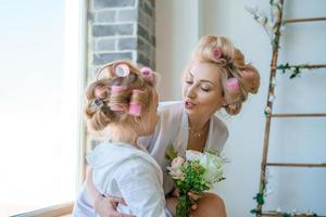 funny mom and daughter in curlers play photo
