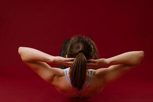 Woman goes in for sports on a red background photo