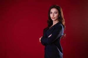 Business woman posing over red background photo