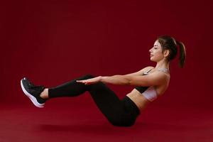 Young woman on a red background is engaged in training photo