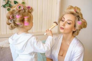 mom and daughter together happy in curlers photo