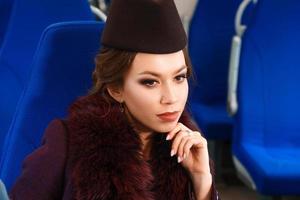 Portrait of a beautiful brunette woman with makeup in a train car photo