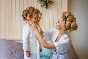 mom and daughter make a make-up to each other, happy family relationship photo