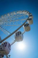 Ferris wheel against a blue sky on a Sunny day photo