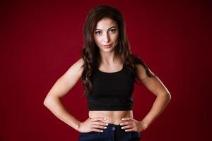 portrait of a brunette girl on a red background photo