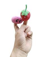 Cute strawberry and peach finger puppets on white background photo
