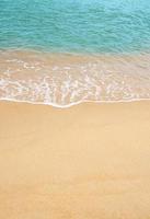 Sand beach and Blue ocean with soft wave form on Sand Texture, Brown Beach sand dune in sunny day Spring, Vertical top view for Summer banner background. photo