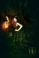 Halloween concept.A teenage girl in a witch costume and a lantern in her hands for Halloween. photo