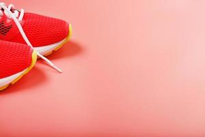 Jogging pink sneakers on a pink background with free space. photo