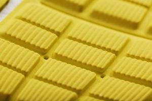 Close-up of the tread of a yellow sneaker, the textured pattern of the sole. photo