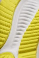 Textured design of the sole of the Tread of a sneaker in yellow Macro. photo