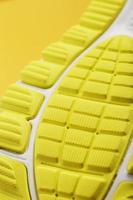 Textured design of the sole of the Tread of a sneaker in yellow Macro. photo