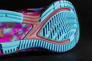 Turquoise outsole tread with sports sneakers for jogging and fitness. Sports style, close-up photo