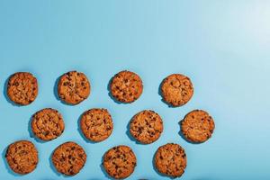 Oatmeal cookies with chocolate chip pattern and patterns on a light blue background. photo