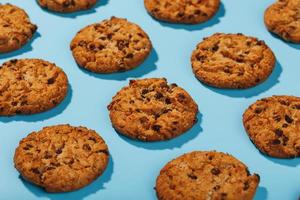 Oatmeal cookies with chocolate chip pattern and patterns on a light blue background. photo